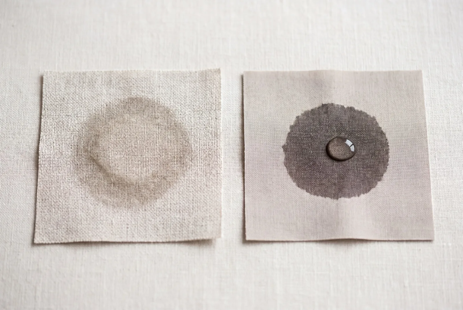 Wet-patch test — water disperses into ARKEN linen on the left; synthetic blend on the right holds the droplet as a dark wet patch